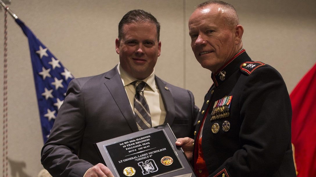 Lt. Gen. Lawrence D. Nicolson (right), commanding general of III Marine Expeditionary Force, is presented a plaque by Matthew Chase, retired Gunnery Sergeant, 1st Battalion, 25th Marine Regiment, 4th Marine Division, during 25th Marine Regiment’s 10-year reunion of their deployment to Fallujah, Iraq, in Boston, Oct. 8, 2016. Nicholson was the guest of honor at the reunion and spoke to the Marines and Sailors about the importance of looking out for each other and preserving the brotherhood that was developed during their deployment. 