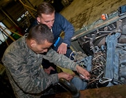 (From left) Senior Airman Cody Crawford, 5th Maintenance Squadron aerospace ground equipment journeyman, and Airman 1st Class Jeremy Graff, 5 MXS AGE apprentice, work on a malfunctioning engine at Minot Air Force Base, N.D., Oct. 5, 2016. The AGE Airmen are responsible for upholding equipment standards by performing routine maintenance and inspections. (U.S. Air Force photo/Airman 1st Class Jonathan McElderry) 