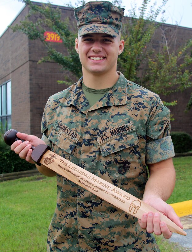Lance Cpl. David Sigdestad holds his trophy for winning the Leonidas Challenge, a bi-annual event hosted by Marine Wing Communications Squadron 28, 2nd Marine Aircraft wing aboard Marine Corps Air Station Cherry Point, N.C., Oct. 4, 2016. During the competition, participants must be able to demonstrate proficiency in drill and ceremonies, basic Marine Corps knowledge and complete an obstacle course. Sigdestad is a data systems specialist with MWCS-28, 2nd MAW. (U.S. Marine Corps photo by Lance Cpl. Mackenzie Gibson/Released)