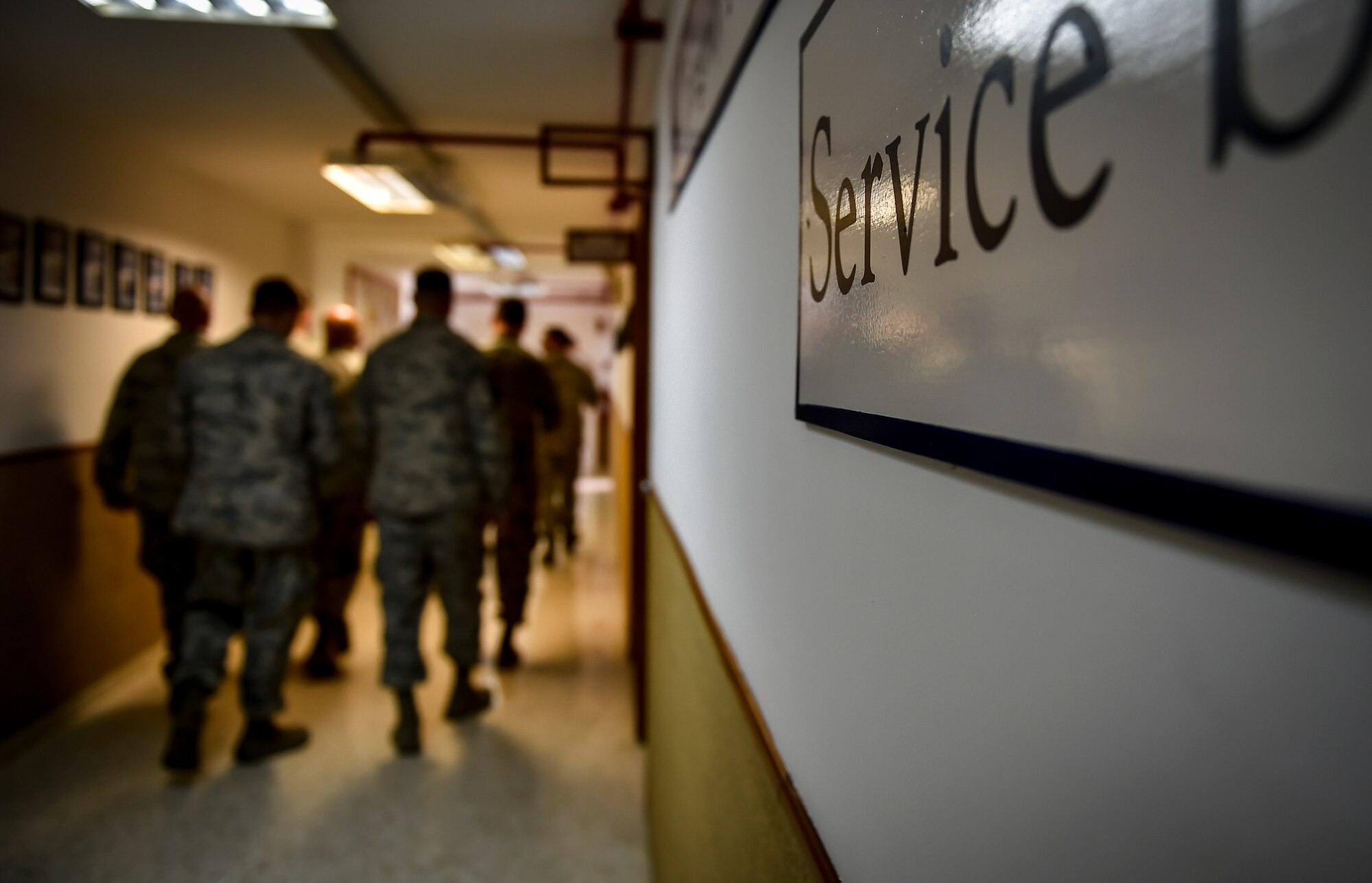 A plaque, with “Service before self,” painted on, is displayed on a wall at Morón Air Base, Spain, Oct. 4, 2016. With a unit of only 600 personnel, Airmen at Morón make up only 25 percent of that population. Team Morón is comprised of U.S. Airmen, Marines and Spanish air force members, who operate together to keep wheels off the ground and in the fight. The 496th Air Base Squadron, a geographically-separated unit from the 86th Airlift Wing, Ramstein Air Base, Germany, provides a worldwide platform for air power. (U.S. Air Force photo by Senior Airman Nicole Keim)