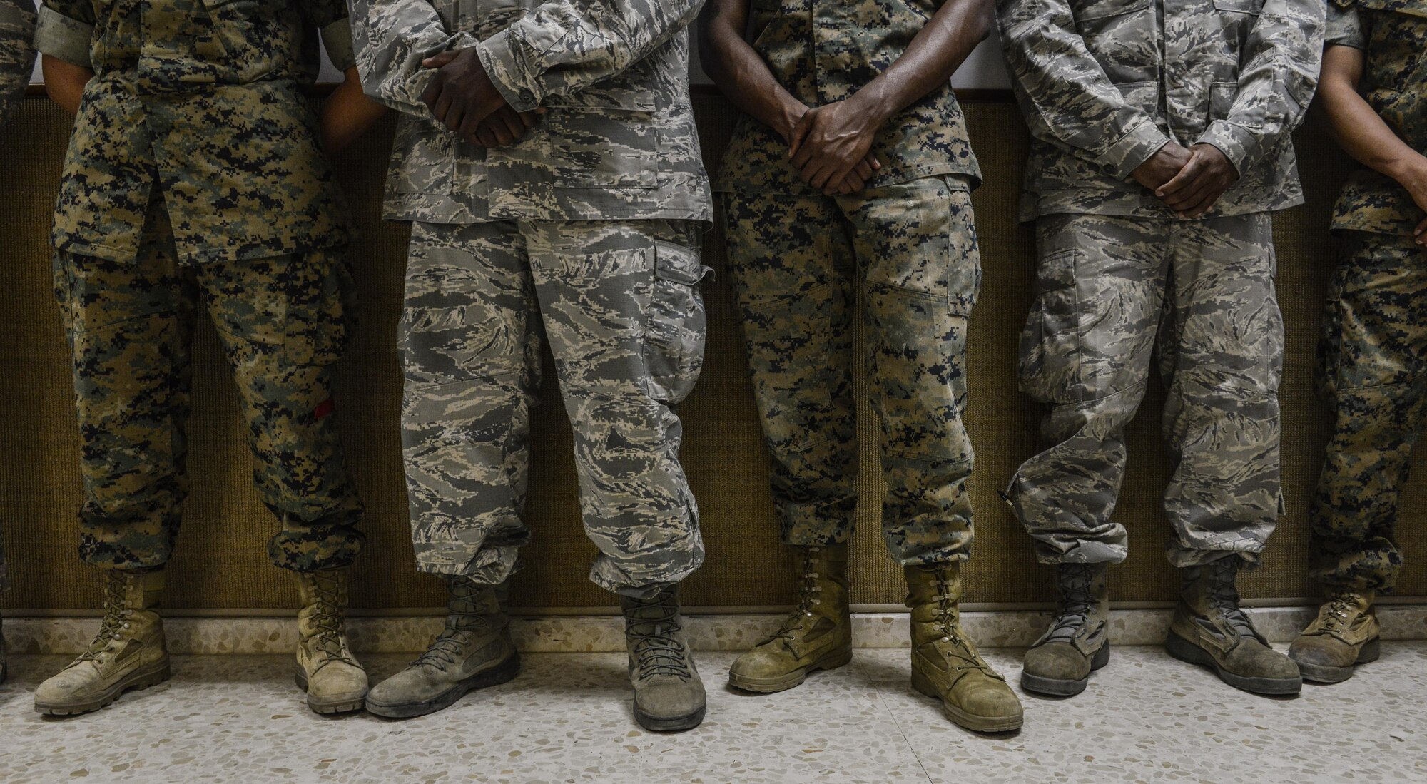 Airmen and Marines stand in line during a briefing from leaders at the 86th Airlift Wing, at Ramstein Air Base, Germany, at Morón Air Base, Spain, Oct. 4, 2016. With a unit of only 600 personnel, Airmen at Morón make up only 25 percent of that population. Team Morón is comprised of U.S. Airmen, Marines and Spanish air force members, who operate together to keep wheels off the ground and in the fight. The 496th Air Base Squadron, a geographically-separated unit from the 86th Airlift Wing, Ramstein Air Base, Germany, provides a worldwide platform for air power. (U.S. Air Force photo by Senior Airman Nicole Keim)
