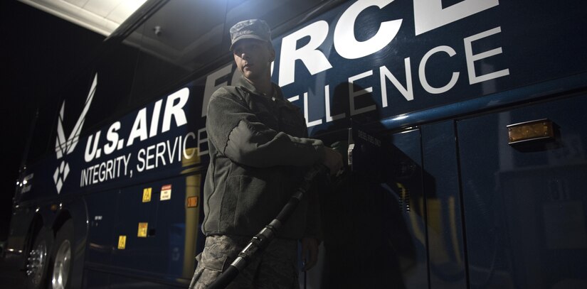 Airman Cody Charles, 11th Logistics Readiness Squadron vehicle operator, pumps gas into a charter bus in New Jersey, Oct. 9, 2016. Charles drove approximately 20 hours to Boston and back to support the Air Force Honor Guard temporary duty mission. (U.S. Air Force photo by Senior Airman Philip Bryant)