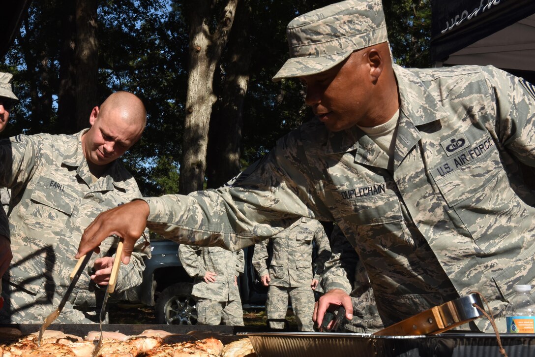 Chief Master Sgt. Anthony Duplechain, 4th Operations Group superintendent, grills chicken as part of a hot meal drive for Team Seymour members affected by Hurricane Matthew, Oct. 12, 2013, at Seymour Johnson Air Force Base, North Carolina. The meals consisted of grilled chicken, beans, vegetables and a dinner roll.