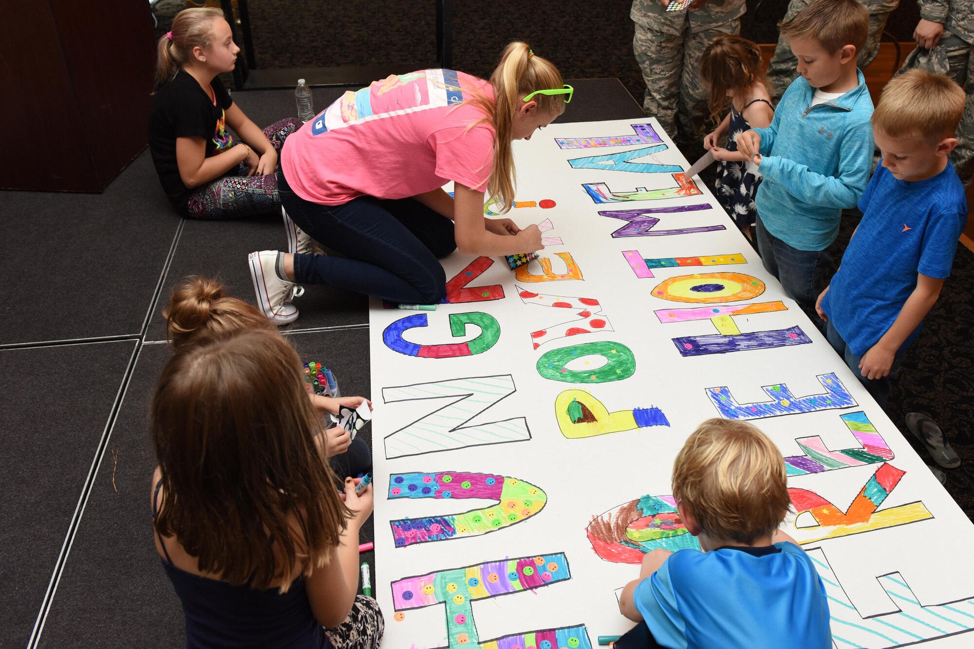 Members of Team Seymour create signs for a drive that provided hot meals to families affected by Hurricane Matthew, Oct. 12, 2016, at Seymour Johnson Air Force Base, North Carolina. Many families lost power, food and even their homes during the severe flooding caused by the hurricane. 