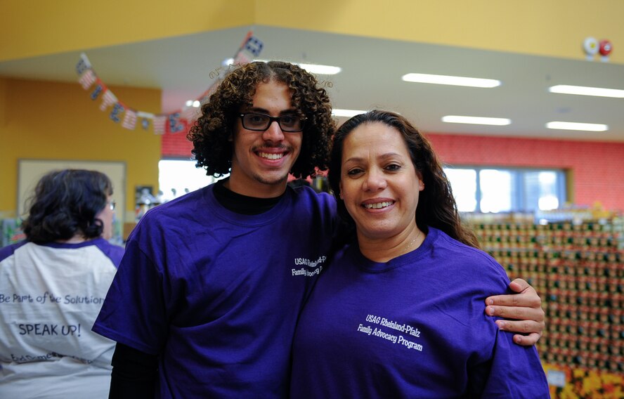 Giovanni Laboy Valentin and his mother, Patricia Laboy Valentin, volunteer for a domestic violence awareness freeze mob at Ramstein Air Base, Germany, Oct. 13, 2016. The Army Community Service Family Advocacy Program in Rheinland-Pfalz strives to improve the quality of life for military families by holding these events to raise awareness for domestic violence. (U.S. Air Force photo by Airman 1st Class Savannah L. Waters)