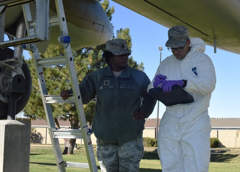 Maj. Christina Peace and Airman 1st Class Adam Miller, 341st Medical Operations Group Bioenvironmental Engineering team, examine information from a radiation detection sweep Oct. 13, 2016, at Malmstrom Air Force Base, Mont.  Aircraft on display at the base museum are checked every three to five years to ensure they do not contain any radioactive components.  (U.S. Air Force photo/Jason Heavner)