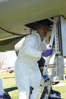 Senior Airman Eugenio Aquino-Aguilar, 341st Medical Operations Squadron bioenvironmental team, climbs into the fuselage of a B-25 Mitchell bomber that’s part of the museum display at Malmstrom Air Force Base, Oct. 12, 2016.  Due to the aircraft containing paints and chemicals that are considered toxic in present day, Aguilar is measuring gamma levels throughout the interior of the aircraft to ensure the radiation levels are within government standards.  (U.S. Air Force photo/Jason Heavner)