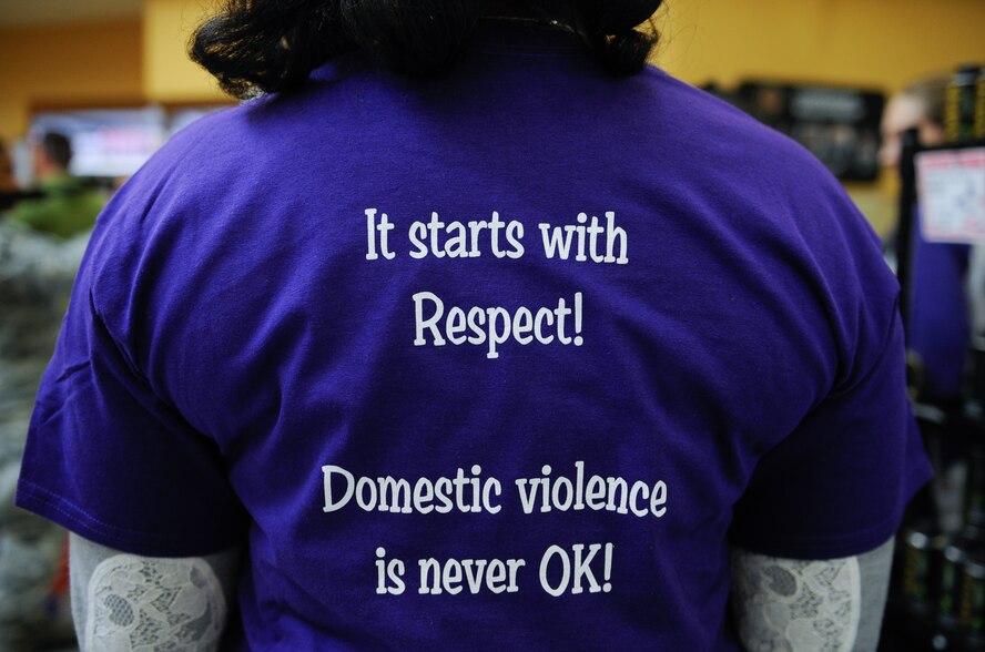 Volunteers for a freeze mob were given a purple domestic violence awareness t-shirt at Ramstein Air Base, Germany, Oct. 13, 2016. The Army Community Service Family Advocacy Program asked for volunteers walking in the door to stand still during a freeze mob at the Ramstein Commissary to help raise awareness for domestic violence. (U.S. Air Force photo by Airman 1st Class Savannah L. Waters)