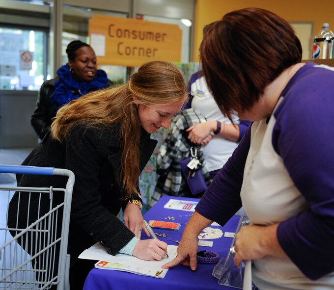 A Ramstein Commissary customer volunteers for a domestic violence awareness freeze mob at Ramstein Air Base, Germany, Oct. 13, 2016. The Army Community Service Family Advocacy Program hosted the event and conducted an outreach table at the store to talk about domestic violence. October is domestic violence awareness month. (U.S. Air Force photo by Airman 1st Class Savannah L. Waters)