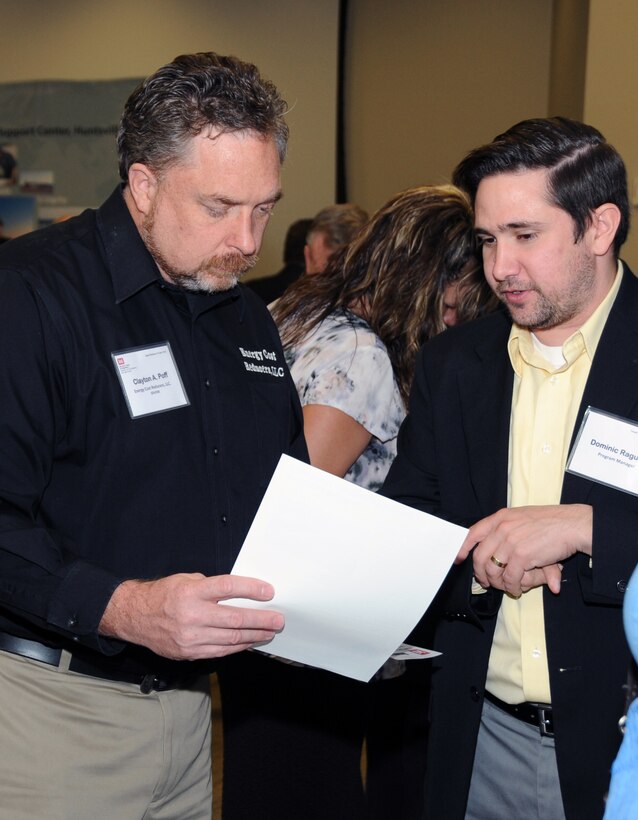 Dominic Raguci, Huntsville Center Energy Division project manager, speaks with Clayton Poff, Energy Cost Reducers LLC, during the Center's 17th Annual Small Business Forum Oct. 12. The event provides an opportunity for small business representatives to discuss their capabilities with Huntsville Center contracting officials and program managers to learn about upcoming Huntsville Center acquisitions. 