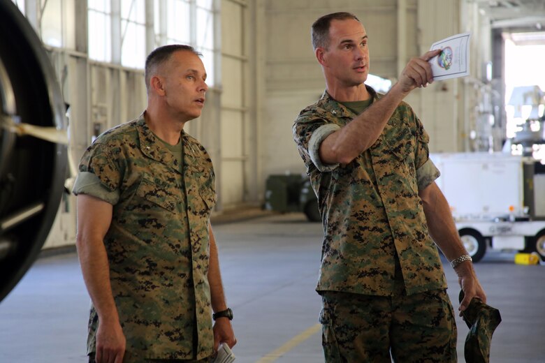 Brig. Gen. Matthew Glavy tours a hanger with Col. Robert Cooper aboard Marine Corps Air Station Beaufort, S.C., Oct. 14, 2016. Glavy visited to assess the effects of Hurricane Matthew and attend the Marine Fighter Attack Squadron 122 change of command ceremony. Glavy issued the Navy and Marine Corps Achievement Medal to Capt. Seve Aguinaga and commended all the Marines there for their tremendous efforts in preparing and responding to the storm, noting they “were fighting outside of their weight class” after conducting operations normally expected of larger support squadrons to minimize impacts of the hurricane. Cooper is the commanding officer with Marine Aircraft Group 31. (U.S. Marine Corps photos by Lance Cpl. Mackenzie Gibson/Released)