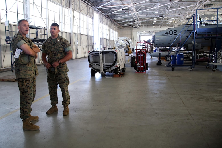 Brig. Gen. Matthew Glavy tours a hanger with 1st Lt. Arturo Sandoval aboard Marine Corps Air Station Beaufort, S.C., Oct. 14, 2016. Glavy visited to assess the effects of Hurricane Matthew and attend the Marine Fighter Attack Squadron 122 change of command ceremony. Glavy issued the Navy and Marine Corps Achievement Medal to Capt. Seve Aguinaga and commended all the Marines there for their tremendous efforts in preparing and responding to the storm, noting they “were fighting outside of their weight class” after conducting operations normally expected of larger support squadrons to minimize impacts of the hurricane. Sandoval is the aircraft maintenance officer with VMFA-122. (U.S. Marine Corps photos by Lance Cpl. Mackenzie Gibson/Released)