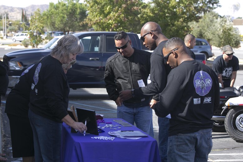 Combat Center Marines talk with members of the Unity Home in Yucca Valley, Calif., during the 3rd Annual Domestic Violence Awareness Poker Run Motorcycle Ride as part of Domestic Violence Awareness Month, Oct. 7, 2016. (Official Marine Corps photo by Cpl. Thomas Mudd/Released)