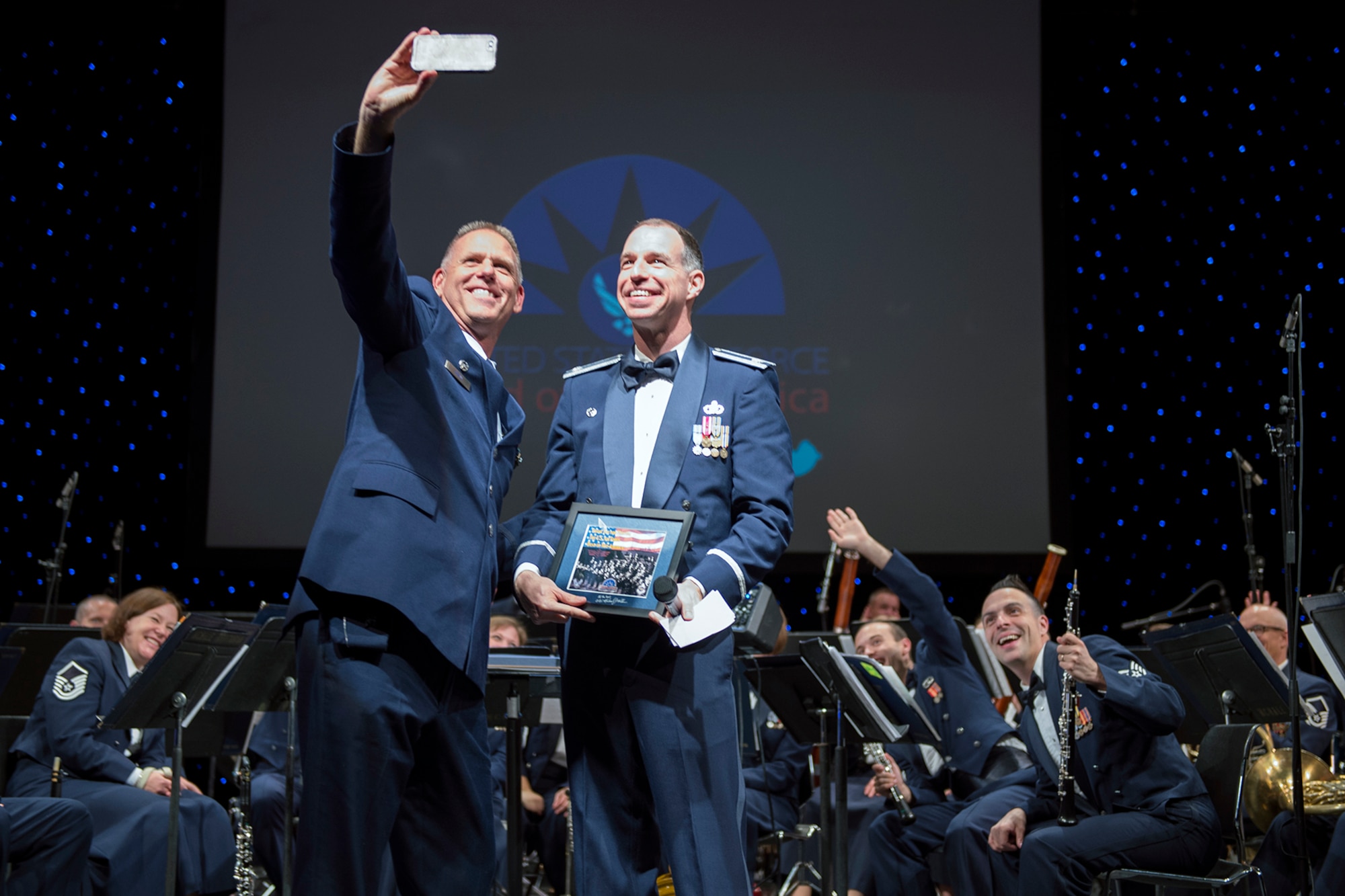 Col. Larry Shaw, 434th Air Refueling Wing commander, takes a selfie with Lt. Col. Michael Willen, U.S. Air Force Band of Mid-America commander, and other band members during a concert in Logansport, Ind. Oct. 11, 2016. The band has a long history of performing for the American public and promoting esprit de corps within the military. (U.S. Air Force photo/Tech. Sgt. Benjamin Mota)
