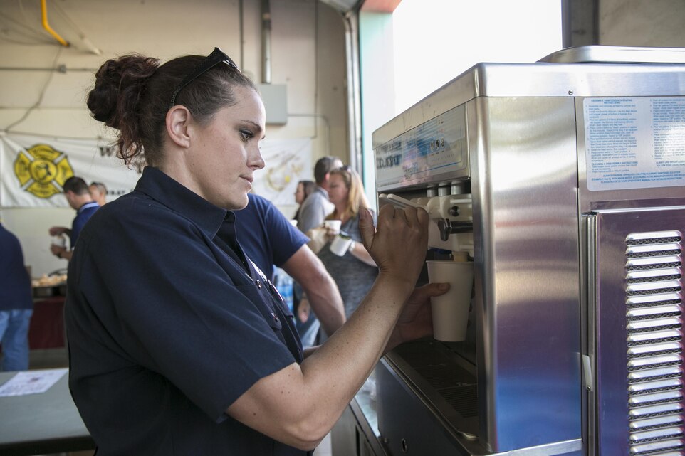 Samantha Vagelatos, firefighter paramedic, Combat Center Fire Department, prepares for root beer floats for the patrons of the base for the Fire Prevention Chili Luncheon at the Fire Station aboard the Marine Corps Air Ground Combat Center, Twentynine Palms, Calif., Oct. 12, 2016. (Official Marine Corps photo by Lance Cpl. Dave Flores/Released)