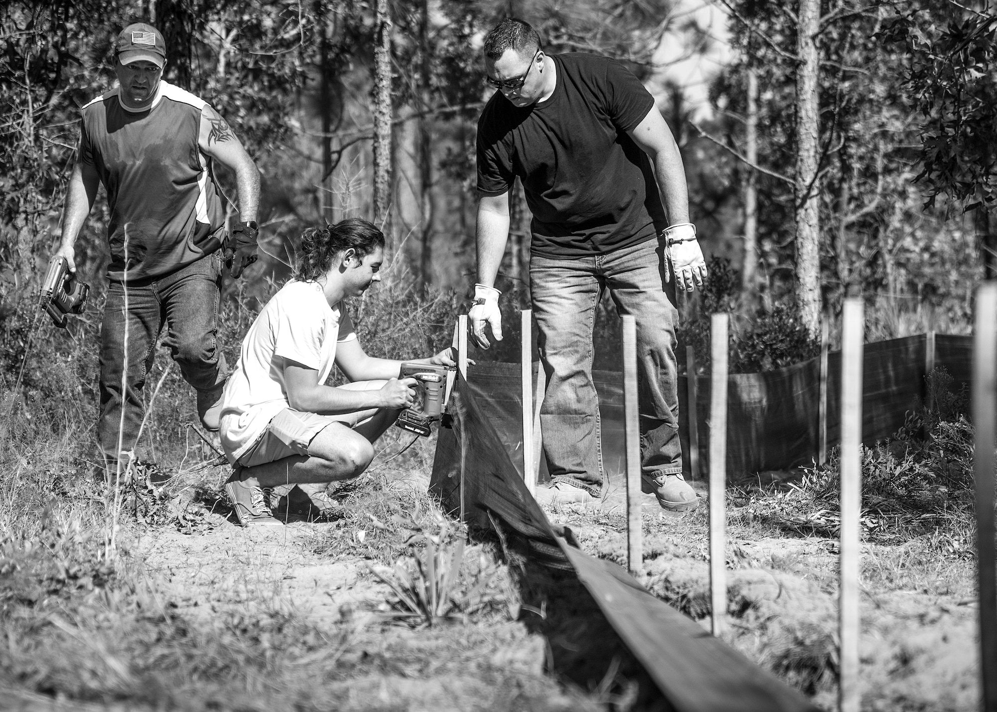 Natural resources personnel and volunteers put silt fencing into place deep within the Eglin Air Force Base range Oct. 13.  The fencing will surround a new habitat for approximately 250 gopher tortoises.  The tortoises are being relocated from South Florida to Eglin escaping certain death from urban development. Approximately 500 gopher tortoises will eventually be moved to the range.   (U.S. Air Force photo/Samuel King Jr.)