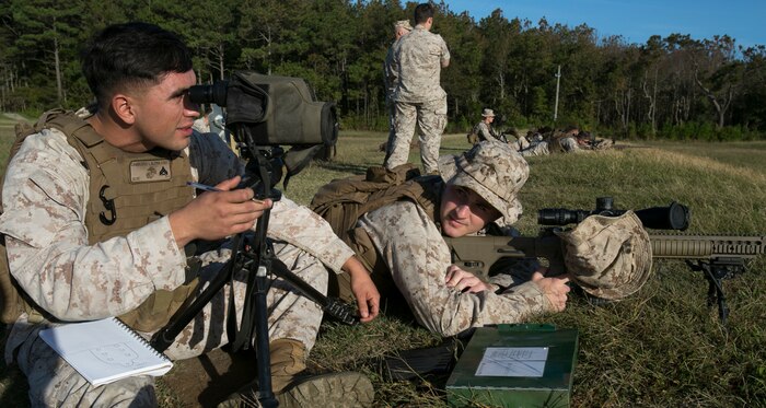 Cpl. Issac Camberos (left) assesses Lance Cpl. Joseph Lambert’s shot group after firing the M110 Semi-Automatic Sniper System during designated marksman sustainment training aboard Naval Air Station Oceana Dam Neck, Va., Oct. 12, 2016.  The six designated marksmen from 6th platoon, Company A, Fleet Anti-Terrorism Security Team, Marine Corps Security Force Regiment, practiced other techniques which included firing from different distances, different positions and engaging multiple targets. (Official U.S. Marine Corps photo by Sgt. Calvin Shamoon/ Released)