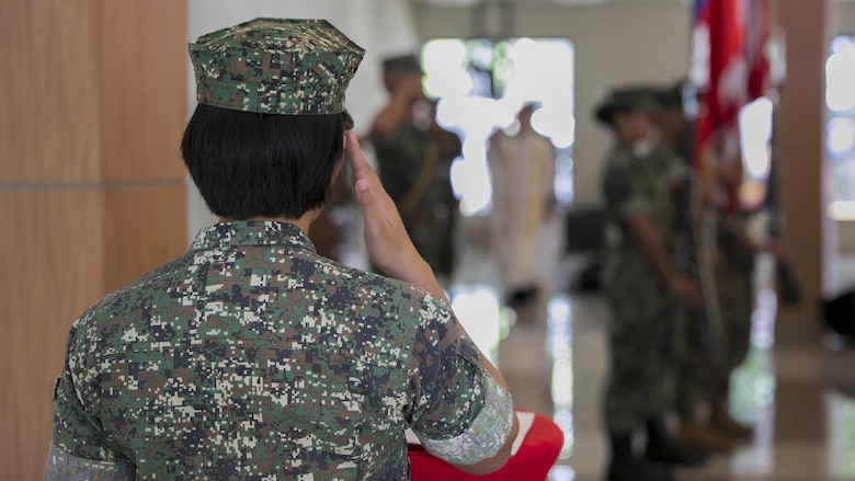 A Philippine Marine salutes the U.S. and Philippine colors during the Philippine Amphibious Landing Exercise 33 closing ceremony at Marine Barracks Rudiardo Brown, Taguig City, Philippines, Oct. 11, 2016. PHIBLEX is an annual U.S.-Philippine military bilateral exercise that combines amphibious capabilities and live-fire training with humanitarian civic assistance efforts to strengthen interoperability and working relationships. 