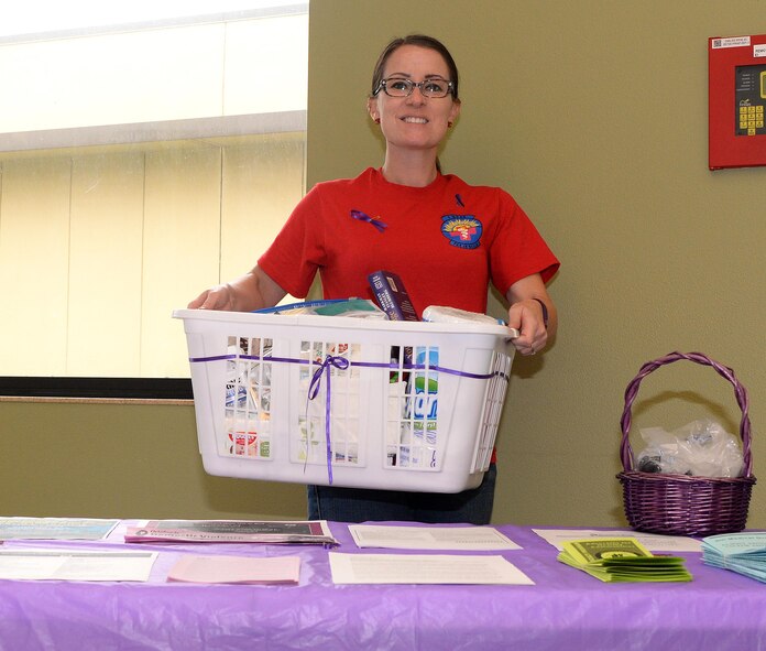 Allysyn Lasch, 9th Medical Operations Squadron family advocacy outreach manager picks up donations made by Beale Airmen Oct. 14, 2016, at Beale Air Force Base, California. Squadrons and Units across base are collecting donations for five local domestic violence shelters Beale is helping. (U.S. Air Force photo/Airman Tristan D. Viglianco)