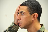 Pvt. Jason Mangual, a mechanic from Long Island, New York, assigned to the U.S. Army Reserve's 357th Chemical Company, reads an eye chart during a 99th Regional Support Command-sponsored mass medical event Oct. 14 at Joint Base McGuire-Dix-Lakehurst, New Jersey.  For more information about MMEs, contact the 99th RSC's Surgeons Office at (609) 562-7455.