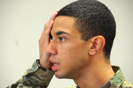 Pvt. Jason Mangual, a mechanic from Long Island, New York, assigned to the U.S. Army Reserve's 357th Chemical Company, reads an eye chart during a 99th Regional Support Command-sponsored mass medical event Oct. 14 at Joint Base McGuire-Dix-Lakehurst, New Jersey.  For more information about MMEs, contact the 99th RSC's Surgeons Office at (609) 562-7455.