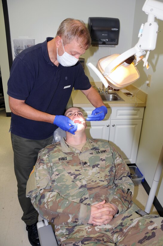 Sgt. Mark Pares, a chemical, biological, radiological and nuclear specialist from Maywood, New Jersey, assigned to the U.S. Army Reserve's 357th Chemical Company, has his teeth checked during a 99th Regional Support Command-sponsored mass medical event Oct. 14 at Joint Base McGuire-Dix-Lakehurst, New Jersey.  For more information about MMEs, contact the 99th RSC's Surgeons Office at (609) 562-7455.