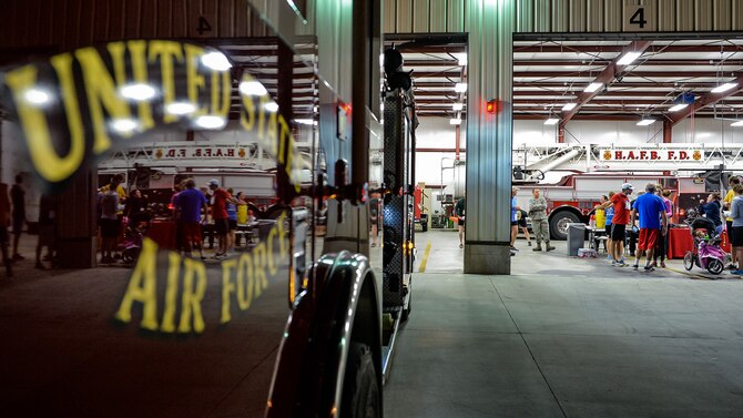 Participants in the 14th annual Firehouse Run are reflected in a fire engine door Oct. 14 at Hill Air Force Base. The 6K and 12K runs followed a course from Hill AFB Fire Station 1 to Fire Station 2. (U.S. Air Force photo by R. Nial Bradshaw)