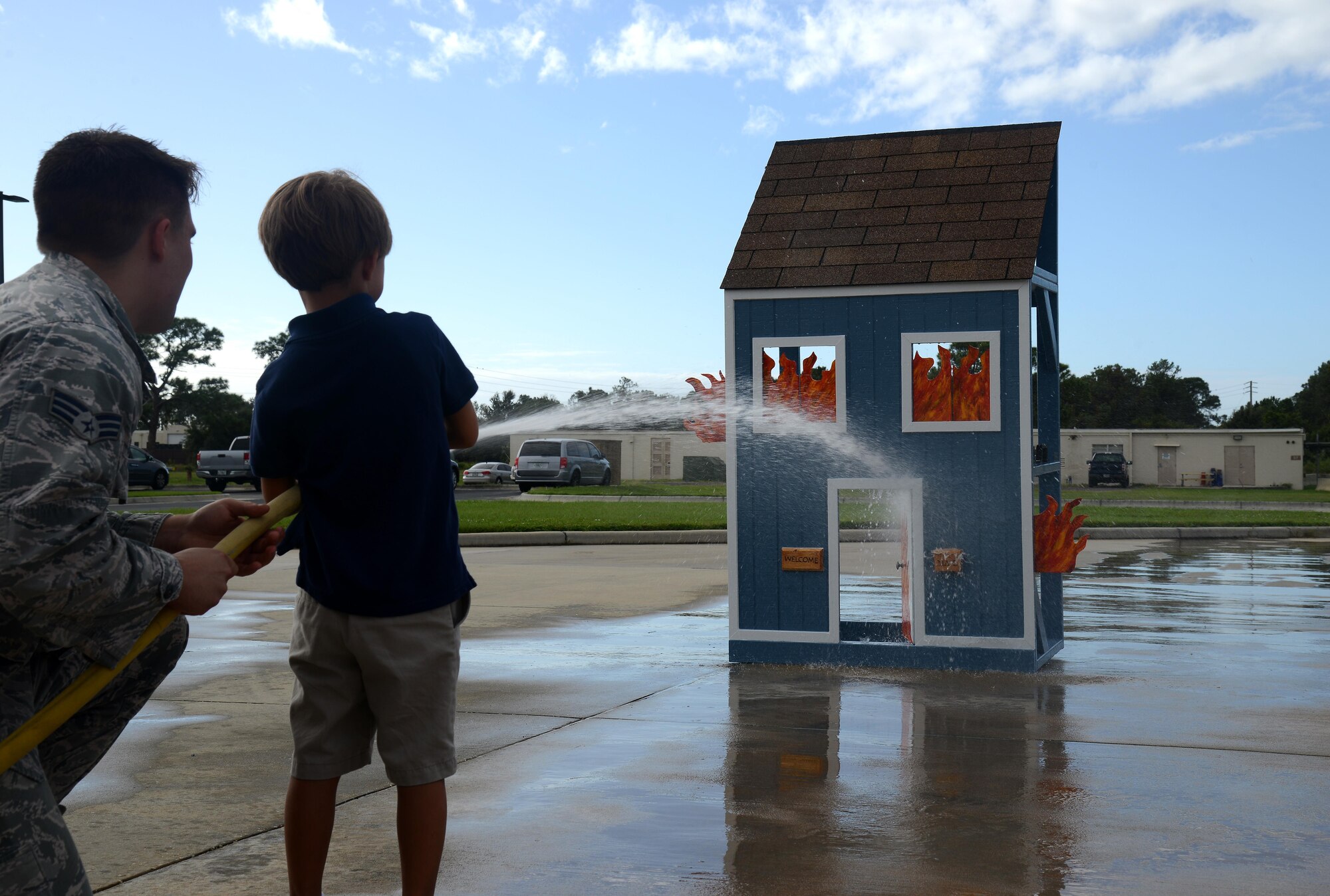 Senior Airman Dennis Lockaby, a firefighter assigned to the 6th Civil Engineer Squadron, teaches a student from Tinker K-8 School about putting out fires at MacDill Air Force Base, Fla., Oct. 12, 2016. Students were shown various things about fire prevention as part of MacDill’s Fire Prevention week. 