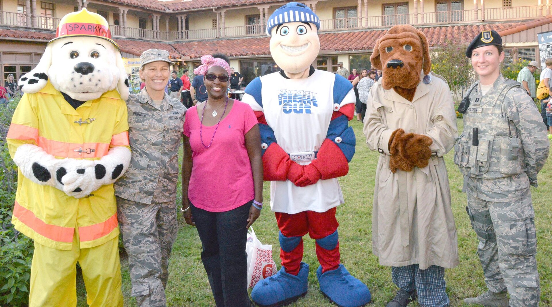 Brig. Gen. Heather L. Pringle (second from left) is joined by (from left) Sparky the Fire Dog; Paula Boykin, 502nd SFLSG budget analyst/resource advisor; Scout the National Night Out Mascot; McGruff the Crime Dog; and Capt. Julie Roloson, 502nd Security Forces Squadron operations officer, during the National Night Out celebration at the Lincoln Family Housing headquarters at 2739 Dickman Drive at JBSA-Fort Sam Houston Oct. 4.