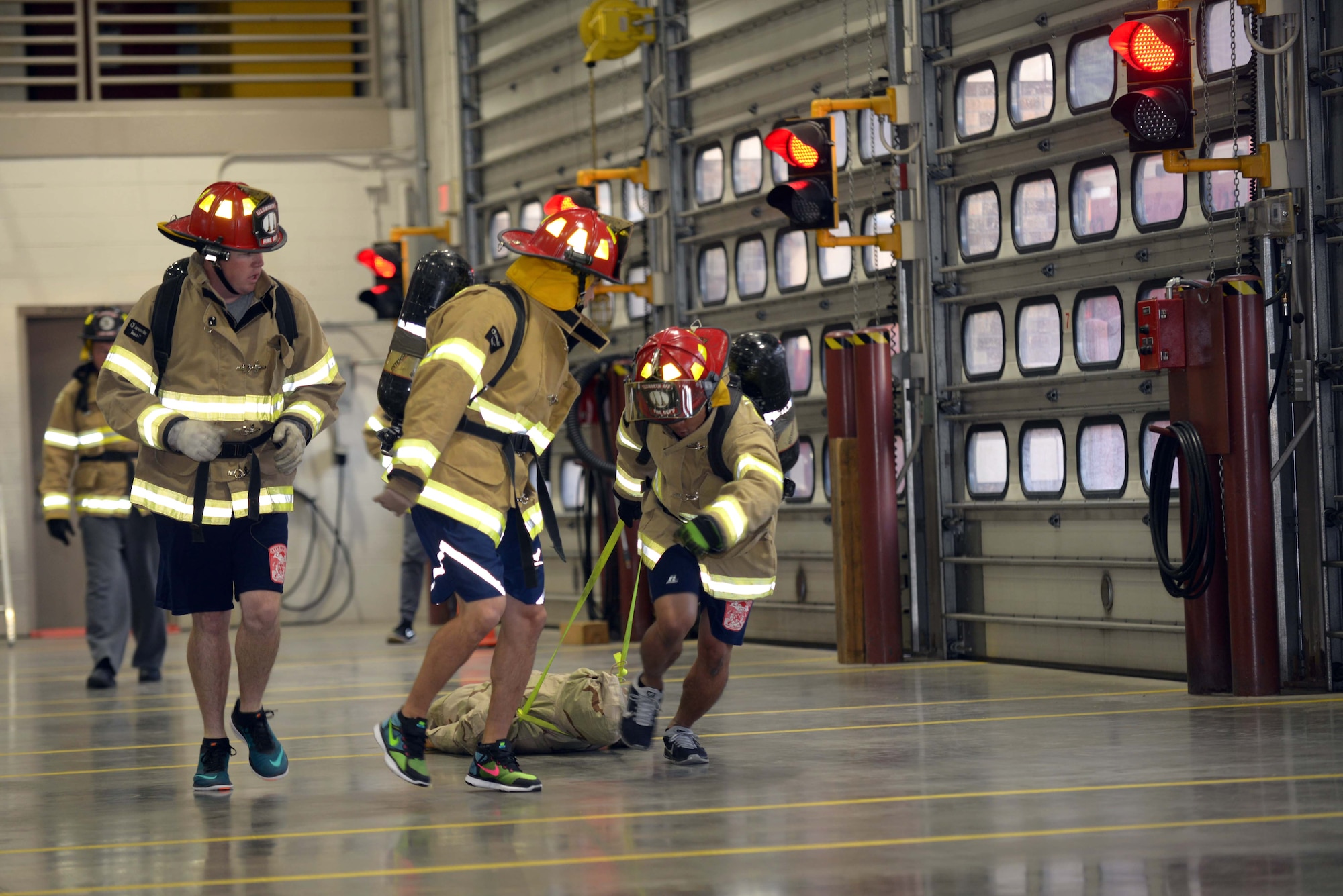 Airmen participate in a rescue dummy drag obstacle during the Firefighter Challenge at Ellsworth Air Force Base, S.D., Oct. 7, 2016. The rescue dummy simulated rescuing an unconscious smoke inhalation victim, weighing approximately 200 pounds. (U.S. Air Force photo by Airman 1st Class Donald C. Knechtel)