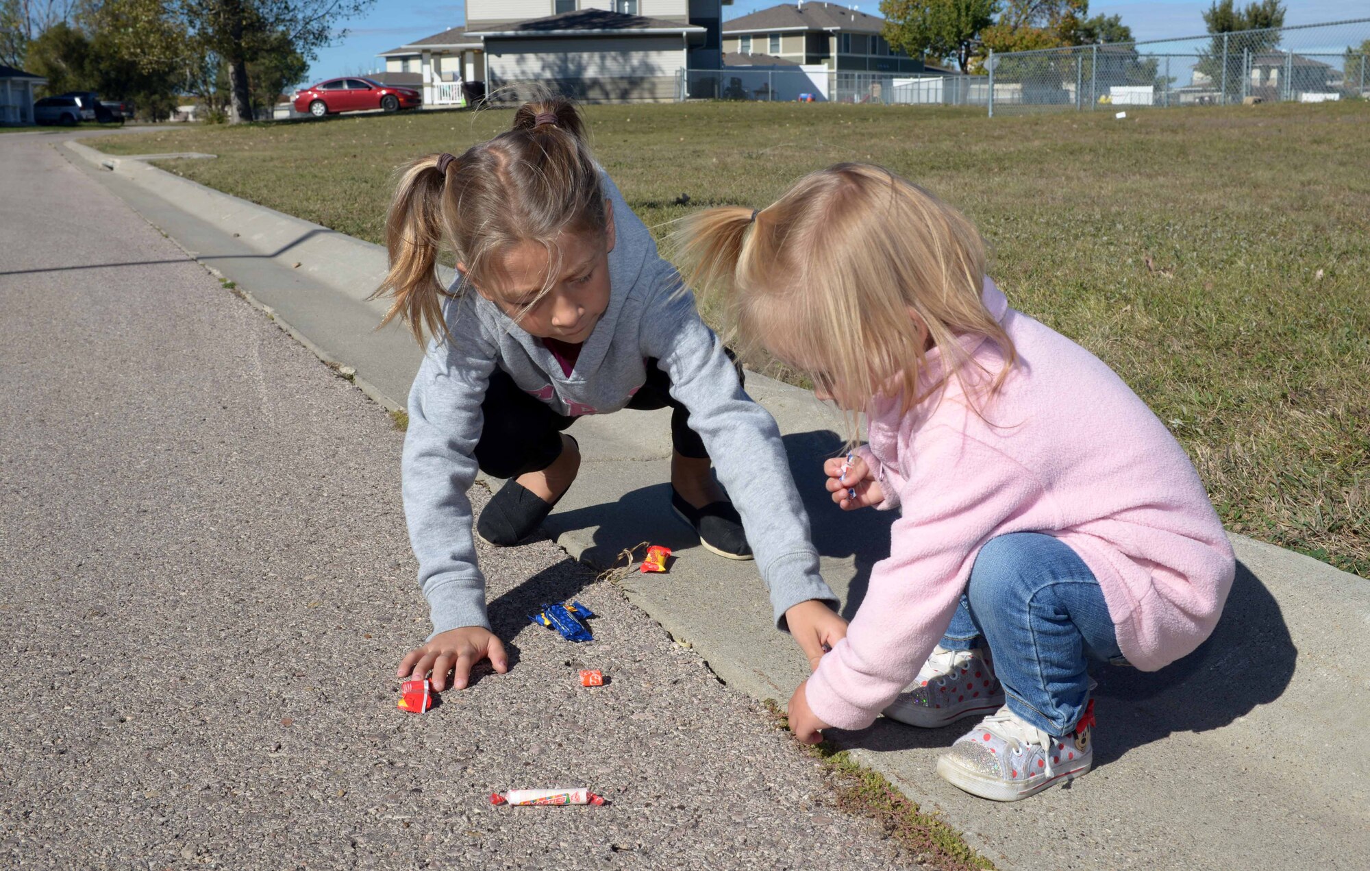 Children pick up candy thrown by 28th Civil Engineer Squadron personnel during a Fire Prevention Week parade at Ellsworth Air Force Base, S.D., Oct. 8, 2016. This year’s theme is “Don’t Wait – Check the Date! Replace Smoke Alarms Every 10 Years,” representing the final stage of a three-year effort to educate the public about essential elements of smoke alarm safety. (U.S. Air Force photo by Airman 1st Class Donald C. Knechtel)