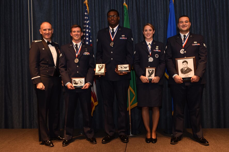 Top honors graduates of Airman Leadership School Class 16 Golf pose for a group photo with Col. Ryan Samuelson, 92nd Air Refueling Wing commander, Oct. 13, 2016, at Fairchild Air Force Base, Wash. ALS is a five-week course designed to prepare Airmen to be professional leaders and supervisors, exemplifying excellence in the profession of arms and communication in the workplace. (U.S. Air Force photo/Airman 1st Class Ryan Lackey)