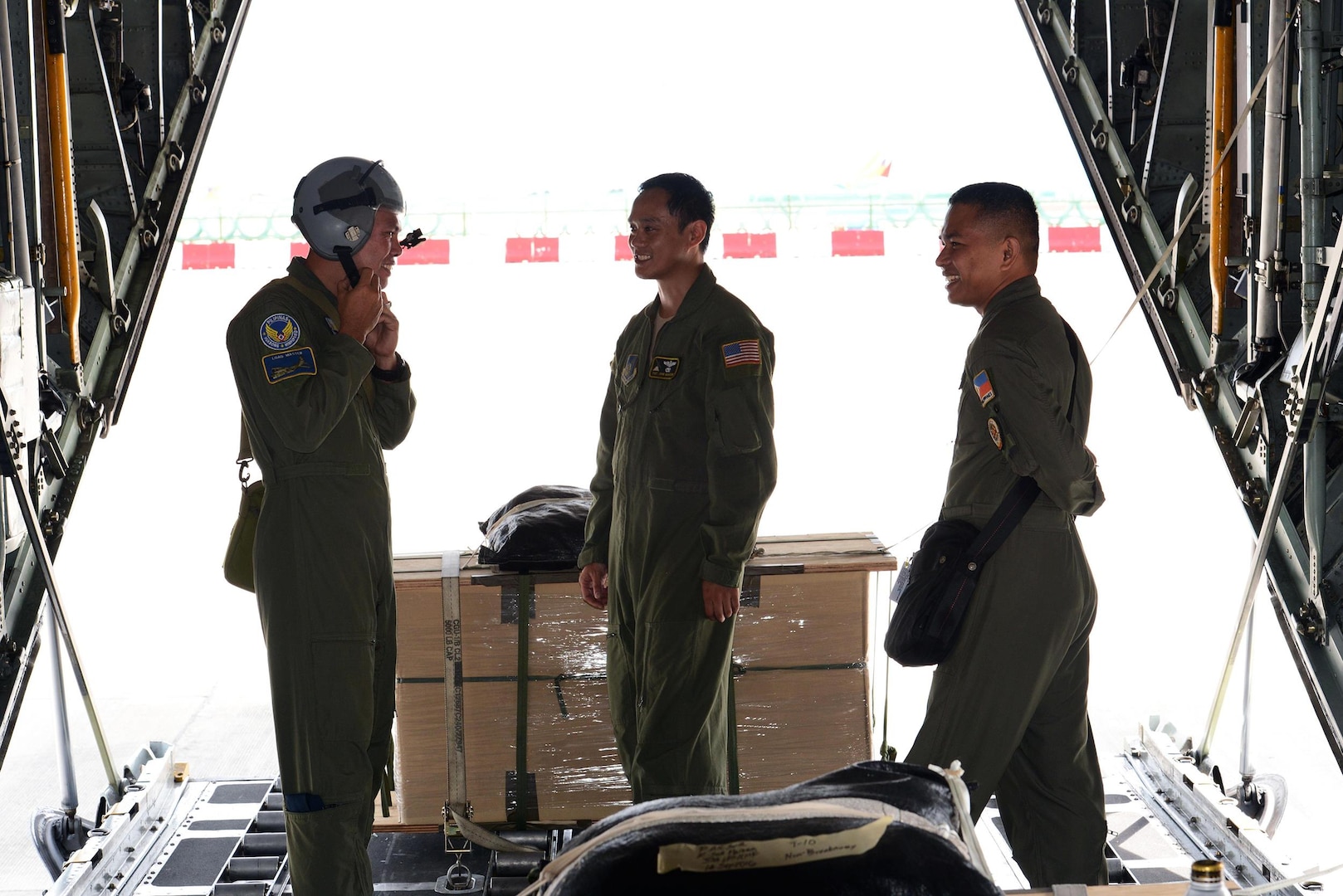 Philippine Air Force C-130 crew members prepare a U.S. Air Force C-130 Hercules aircraft for low-cost, low-altitude airdrop operations with U.S. Air Force Tech. Sgt. John Quiason (middle), 36th Airlift Squadron, 374th Airlift Wing, Yokota Air Base, Japan, during the current iteration of a rotational Air Contingent at Brigadier General Benito N Ebuen Air Base, Lapu-Lapu City, Philippines, Oct. 5, 2016. For the exchange, Yokota-based C-130s flew with members of the Philippine Air Force's 220th Airlift Wing, from Brig. Gen. Benito N. Ebuen Air Base, Lapu-Lapu City, Philippines, and discussed the intricacies of LCLA bundle drops. Two Yokota-based C-130s and crews, members of the 36th Contingency Response Group, Andersen Air Force Base, Guam, and other units from across U.S. Pacific Command conducted bilateral training missions and subject matter expert exchanges alongside their Philippine Air Force counterparts. The Air Contingent is helping build the capacity of the Philippine Air Force and increases joint training, promotes interoperability and provides greater and more transparent air and maritime situational awareness to ensure safety for military and civilian activities in international waters and airspace. Its missions include air and maritime domain awareness, personnel recovery, combating piracy, and assuring access to the air and maritime domains in accordance with international law.