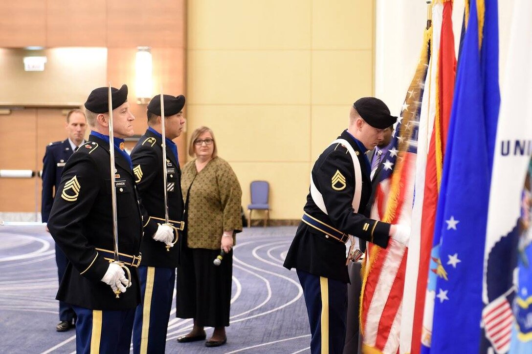 Army Reserve Staff Sgt. Walter Rodgers, right, 85th Support Command, unfurls the nation's colors at the Defense Contract Management Agency-Chicago Change of Leadership ceremony in Schaumburg, Illinois, Oct. 13, 2016.
 The soldiers were requested for a presentation of colors there.
(Photo by Mr. Anthony L. Taylor)