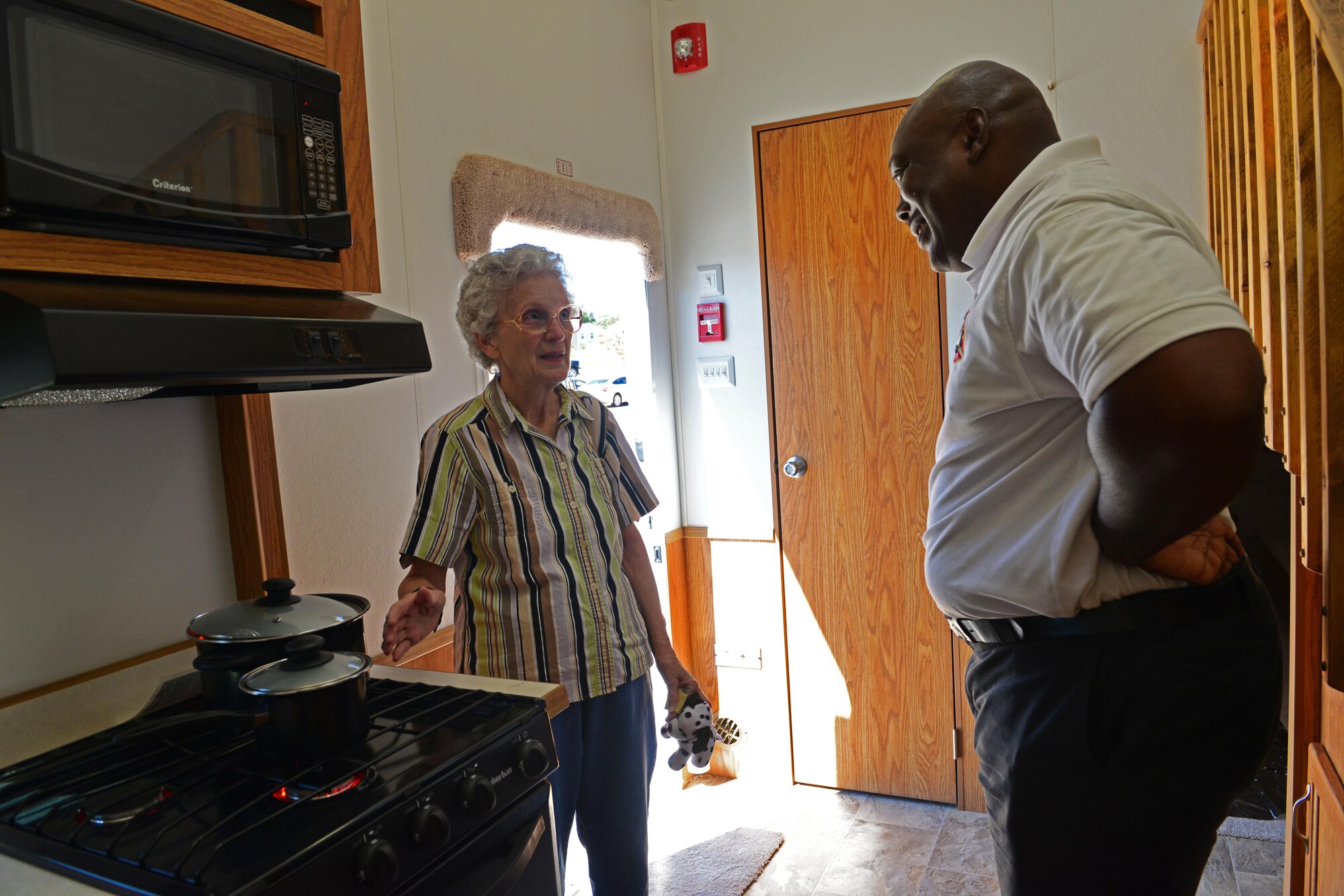 Cornelius Berry, 20th Civil Engineer Squadron fire inspector, answers a Team Shaw member’s questions about stovetops and fire safety at Shaw Air Force Base, S.C., Oct. 11, 2016. The 20th CES fire department hosted a series of events including a smokehouse, an interactive display which simulated various hazards associated with fire, to educate the community on fire safety. (U.S. Air Force photo by Airman 1st Class Destinee Sweeney)
