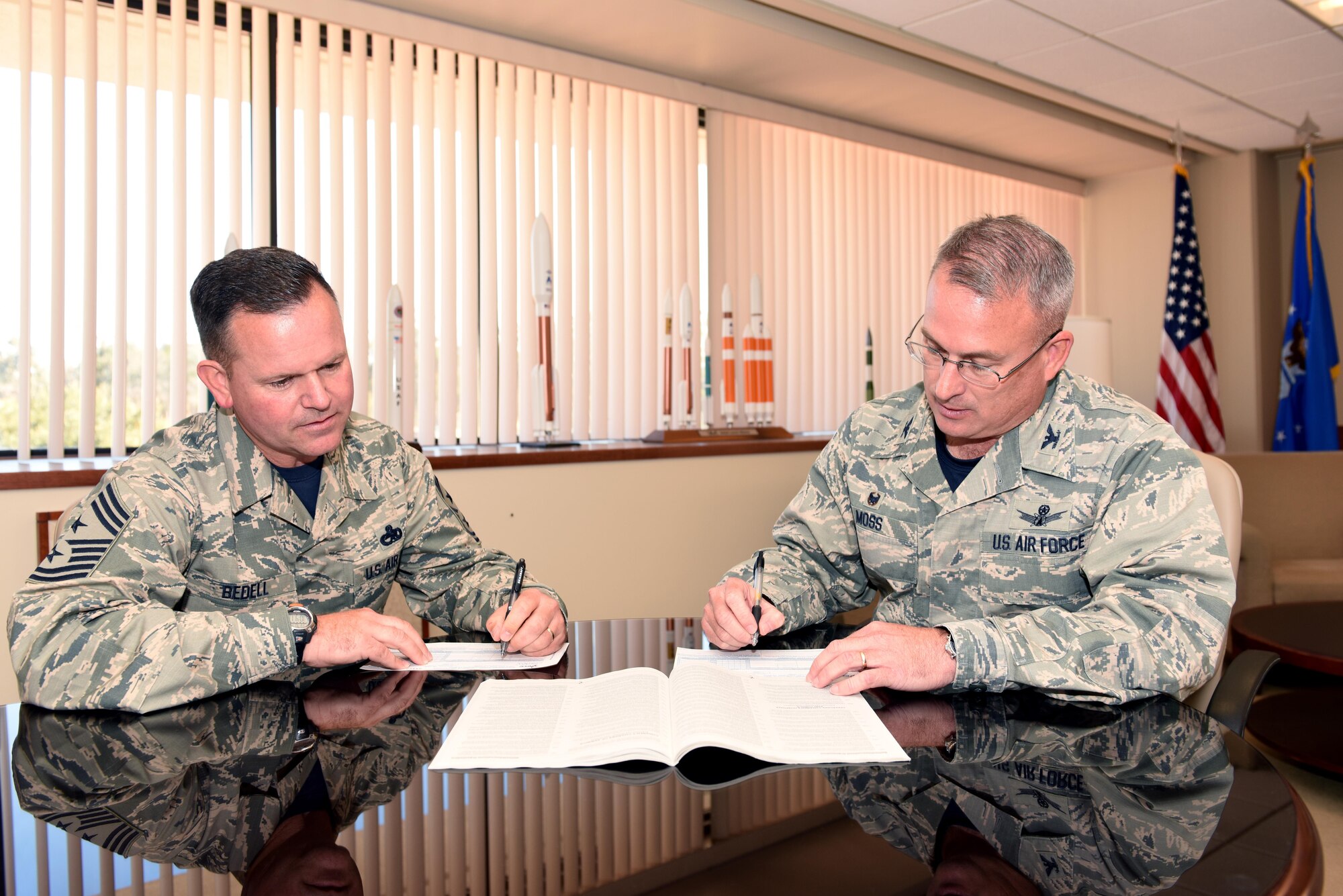 Chief Master Sgt. Robert Bedell, 30th Space Wing command chief, and Col. J. Christopher Moss, 30th Space Wing commander, make the first donations to kick-off the Combined Federal Campaign, Oct. 14, 2016, Vandenberg Air Force Base, Calif. For nearly two months, members of Team Vandenberg will officially seek donations for the 2016 Combined Federal Campaign Oct. 17 through Dec. 9. Pledges made during the campaign will support eligible non-profit organizations that provide health and human service benefits throughout the world. (U.S. Air Force photo by Staff Sgt. Shane Phipps/Released) 