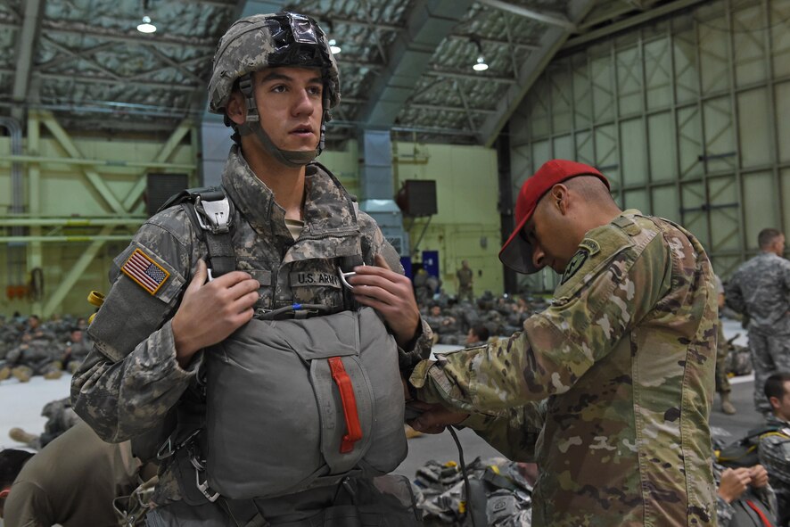 Paratroopers with the 4th Infantry Brigade Combat Team (Airborne), 25th Infantry Division, U.S. Army Alaska, rig up before a jump as part of Red Flag Alaska 17-1 at Joint Base Elmendorf-Richardson, Alaska, Oct. 12, 2016. During Red Flag-Alaska 17-1, approximately 2,095 U.S. service members will participate in the exercise – approximately 1,295 personnel from outside Alaska and 203 international visitors.
