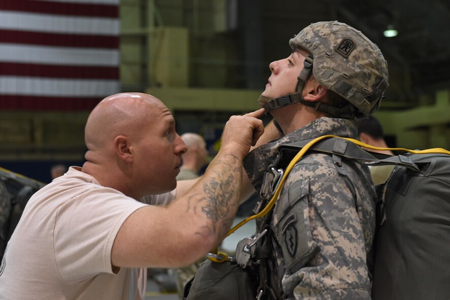 Paratroopers with the 4th Infantry Brigade Combat Team (Airborne), 25th Infantry Division, U.S. Army Alaska, rig up before a jump as part of Red Flag Alaska 17-1 at Joint Base Elmendorf-Richardson, Alaska, Oct. 12, 2016. During Red Flag-Alaska 17-1, approximately 2,095 U.S. service members will participate in the exercise – approximately 1,295 personnel from outside Alaska and 203 international visitors. 