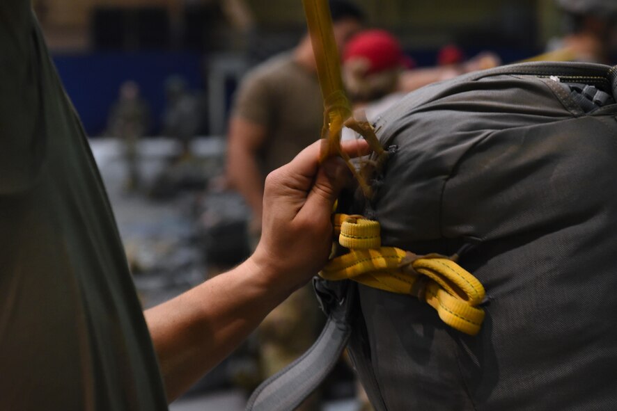 Paratroopers with the 4th Infantry Brigade Combat Team (Airborne), 25th Infantry Division, U.S. Army Alaska, rig up before a jump as part of Red Flag Alaska 17-1 at Joint Base Elmendorf-Richardson, Alaska, Oct. 12, 2016. During Red Flag-Alaska 17-1, approximately 2,095 U.S. service members will participate in the exercise – approximately 1,295 personnel from outside Alaska and 203 international visitors. 