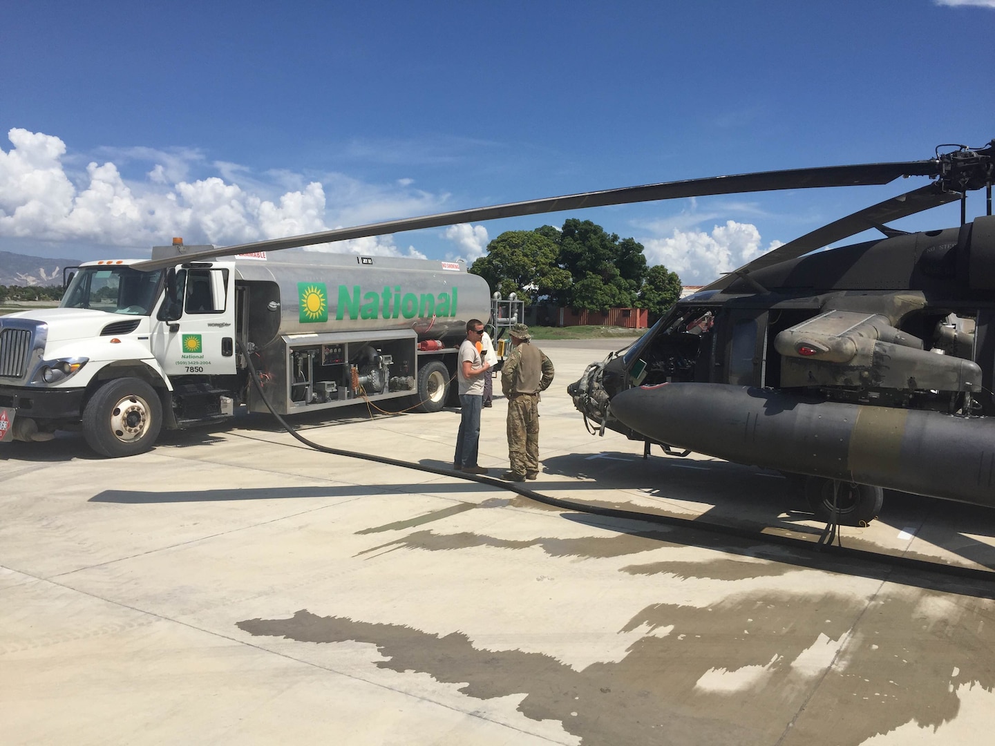 Matt Moshier (left), a DLA Energy customer account specialist, discusses fuel delivery with a pilot from the Army’s 1st Battalion, 228th Aviation Regiment, Port-au-Prince, Haiti, October 2016.