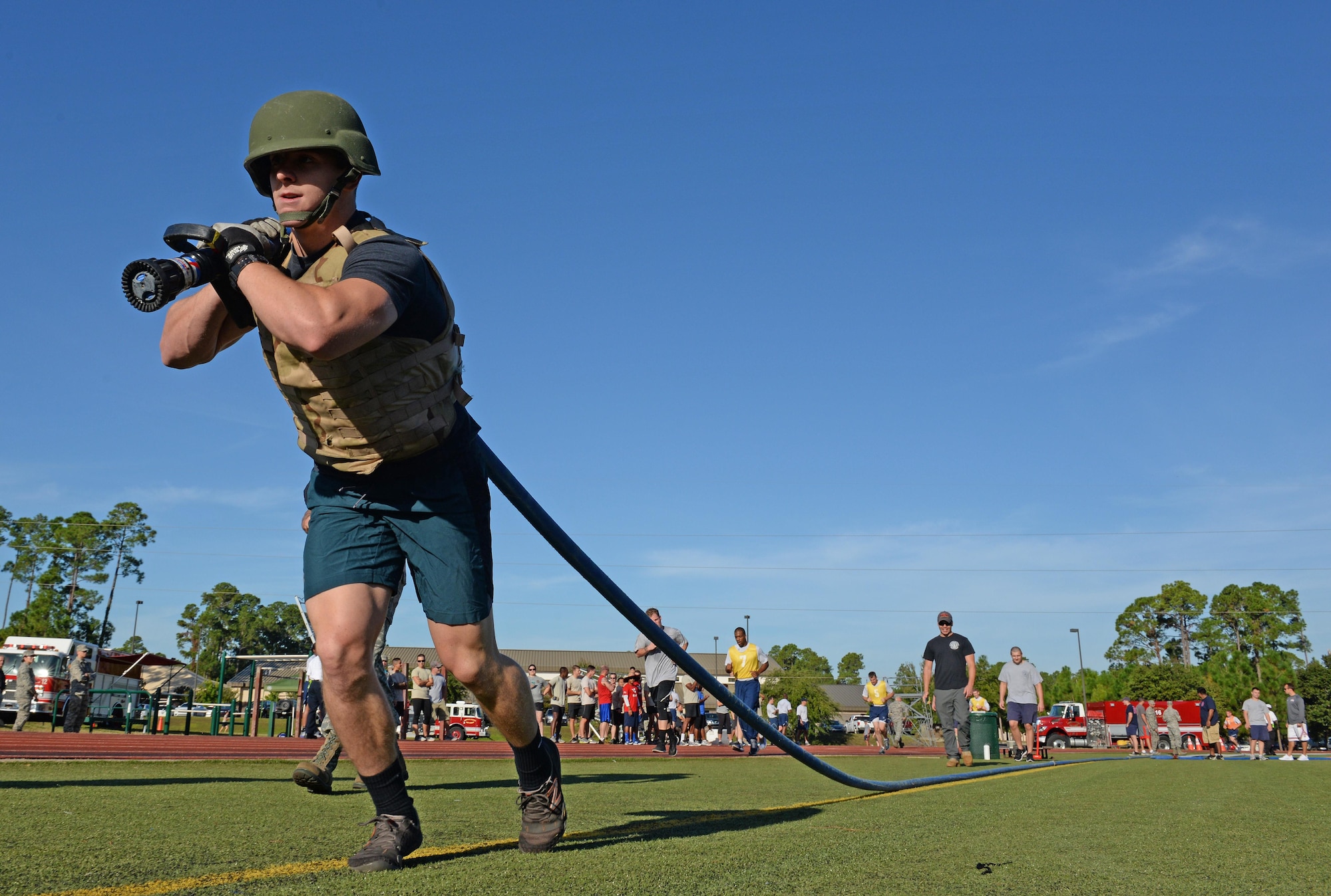 Staff Sgt. Rowland Coyle, an independent duty medical technician – paramedic with the 1st Special Operations Support Squadron, pulls a fire hose during the Fire Prevention Week fire muster challenge at Hurlburt Field, Fla., Oct. 14, 2016. This year’s theme of “Don’t wait, check the date!” informs Airmen to check the dates on fire detectors because they have a life span of 10 years and must be replaced regularly. (U.S. Air Force photo by Senior Airman Andrea Posey)