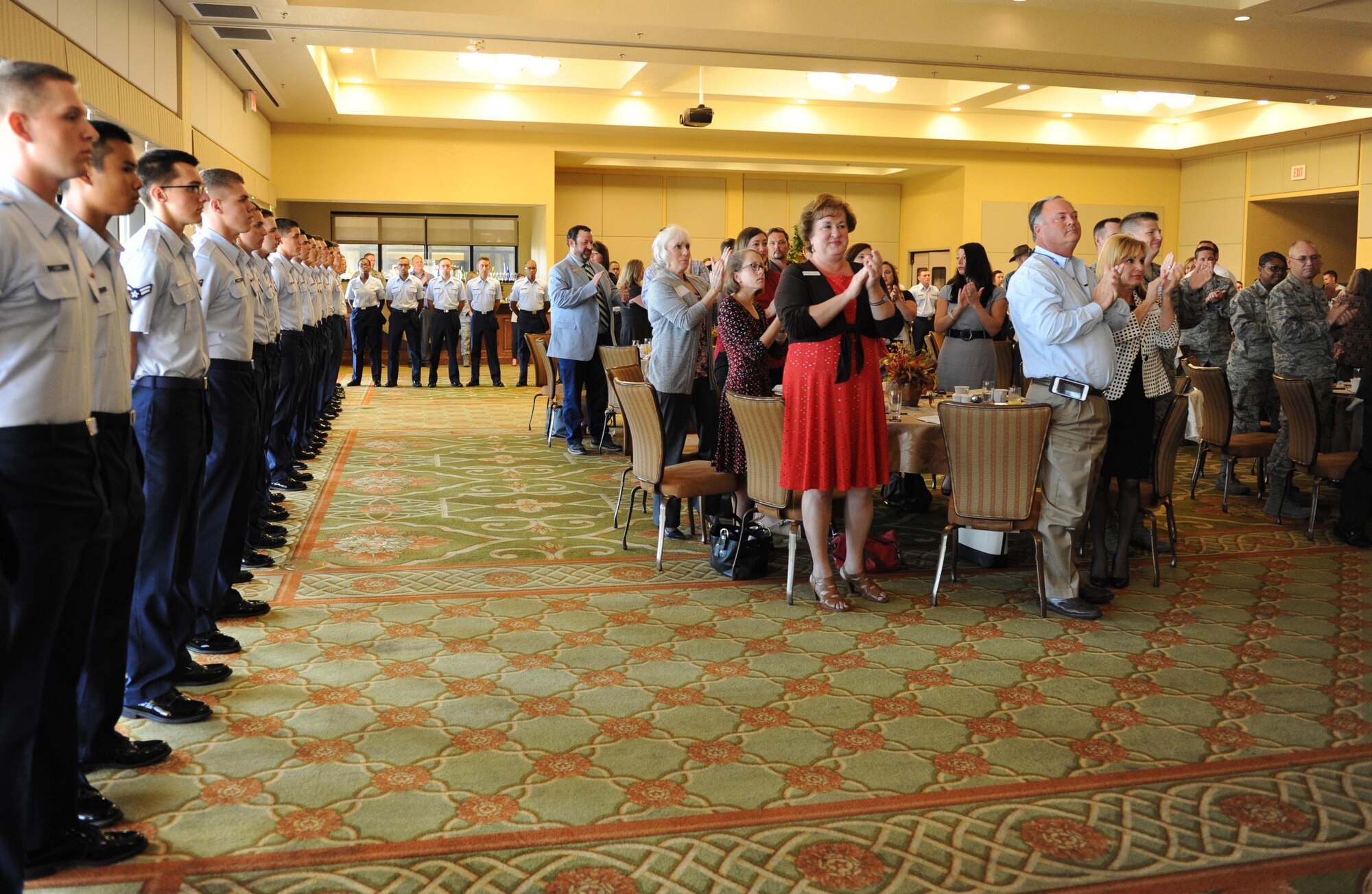 Keesler personnel, community leaders and local business owners give a standing ovation to 336th Training Squadron Airmen for their participation in the quarterly Biloxi Chamber of Commerce Morning Call at the Bay Breeze Event Center Oct. 13, 2016, on Keesler Air Force Base, Miss. Local business and community leaders attended the event to learn more about the base’s mission and its Airmen. During the event, several 81st Training Group Airmen shared their story about why they joined the Air Force. (U.S. Air Force photo by Kemberly Groue/Released)
