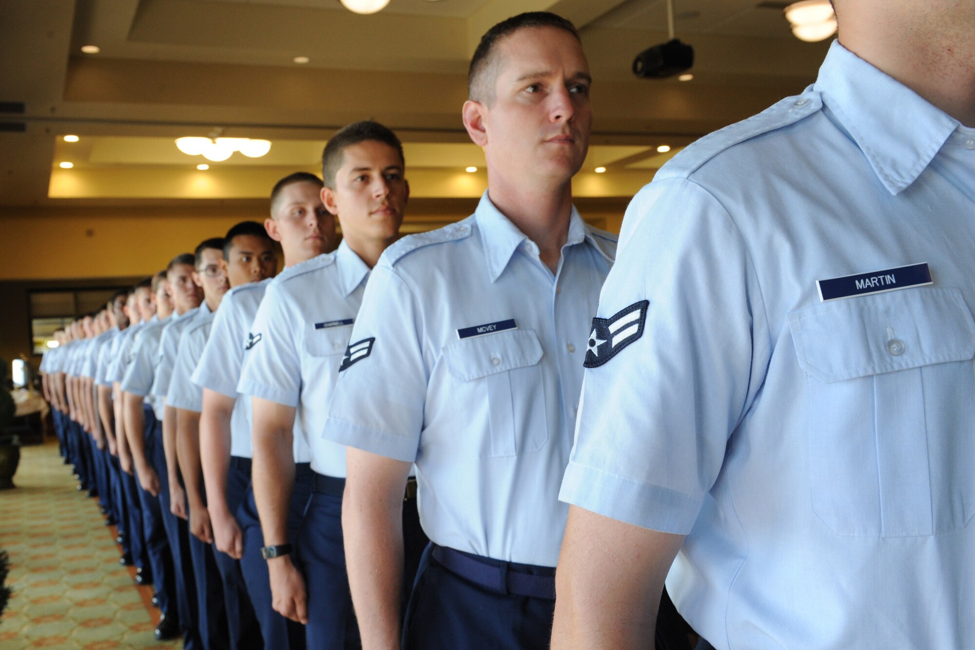 Airmen from the 336th Training Squadron stand at attention during the quarterly Biloxi Chamber of Commerce Morning Call at the Bay Breeze Event Center Oct. 13, 2016, on Keesler Air Force Base, Miss. Local business and community leaders attended the event to learn more about the base’s mission and its Airmen. During the event, several 81st Training Group Airmen shared their story about why they joined the Air Force. (U.S. Air Force photo by Kemberly Groue/Released)