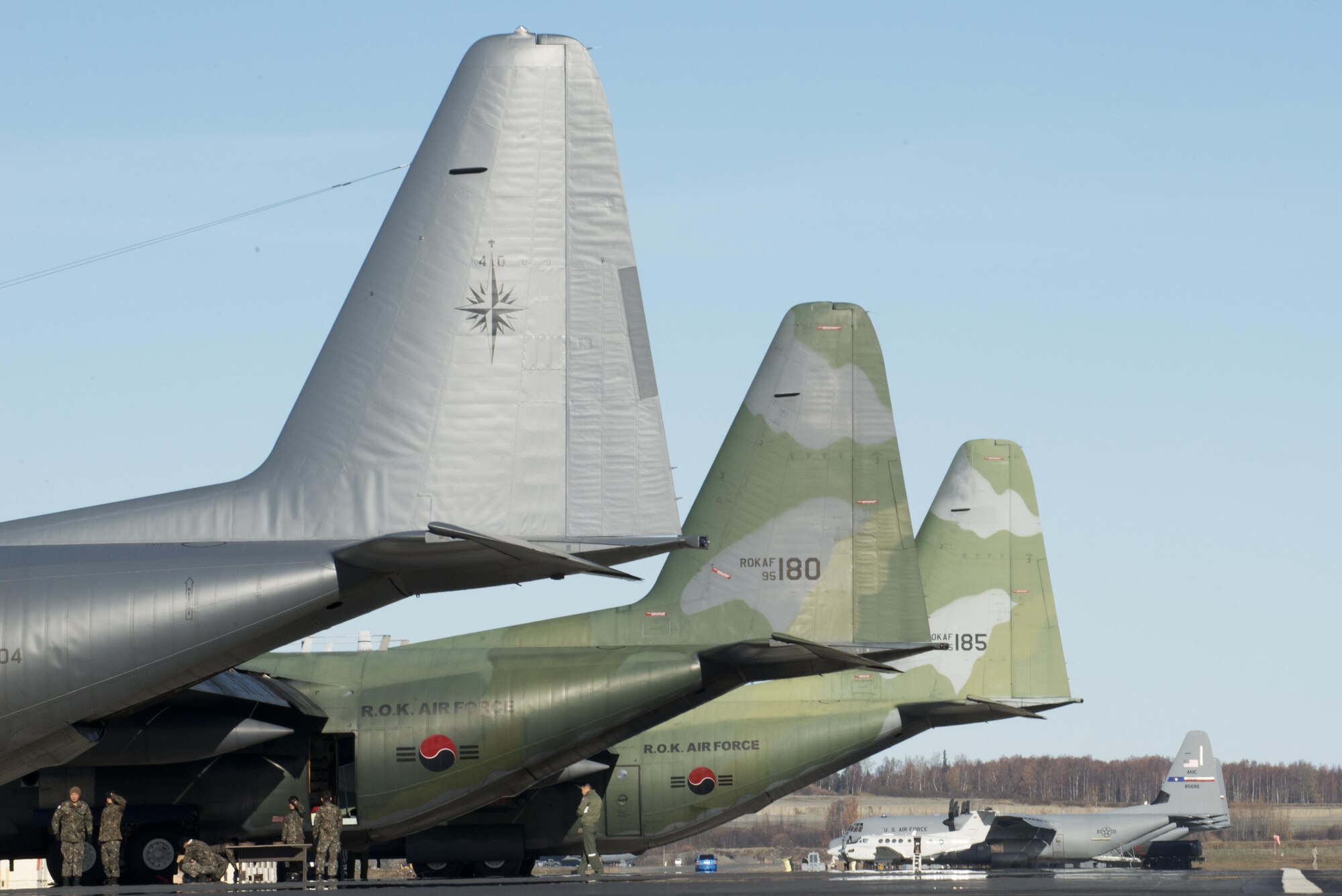 A Royal New Zealand Air Force C-130 Hercules and two Republic of Korea Air Force C-130 Hercules wait on the Joint Base Elmendorf-Richardson, Alaska flightline for their next Red Flag-Alaska 17-1 mission, Oct. 12, 2016. Red Flag-Alaska exercises are focused on improving the combat readiness of U.S. and international forces and providing training for units preparing for air expeditionary force taskings. 