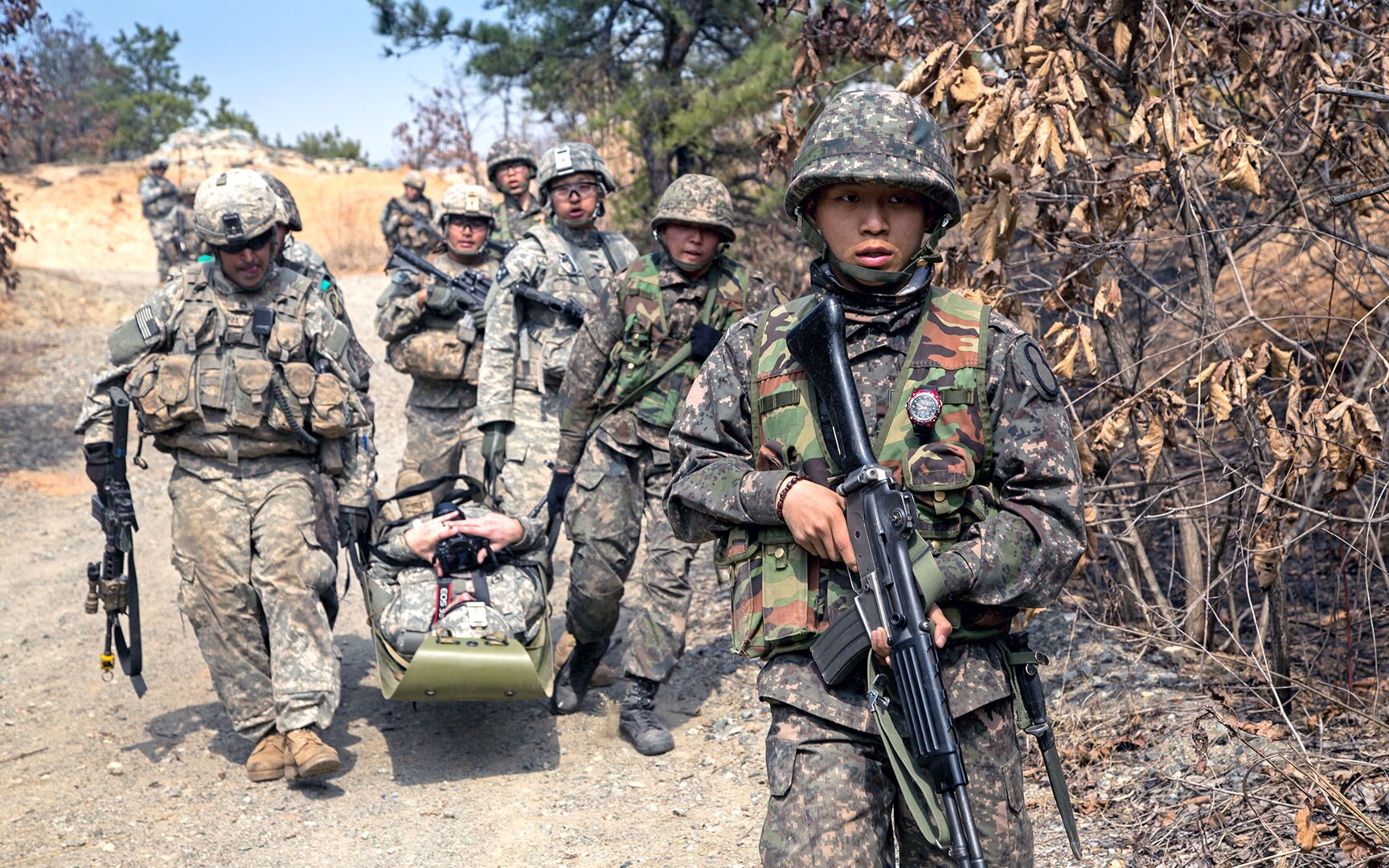 U.S. Soldiers assigned to C Company, 1st Battalion, 27th Infantry Regiment, 2nd Stryker Brigade Combat Team, 25th Infantry Division, move a casualty toward a designated casualty collection point with their Republic of Korea (ROK) Army Soldier counterparts during a platoon live fire training in March near the demilitarized zone in South Korea. 