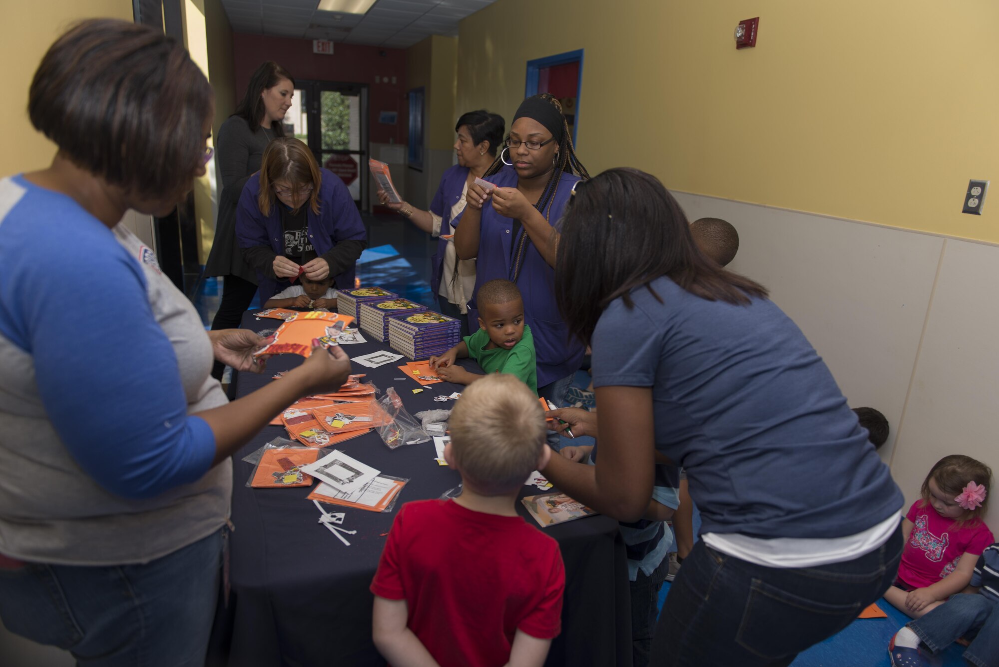 USO and Child Development Center members help children with arts and crafts in the CDC Oct. 12, 2016 on Keesler Air Force Base, Miss. The USO-led event also included a reading of “It’s the Great Pumpkin, Carlie Brown” to commemorate the book’s 50th anniversary. (U.S. Air Force photo by Andre’ Askew/Released)

