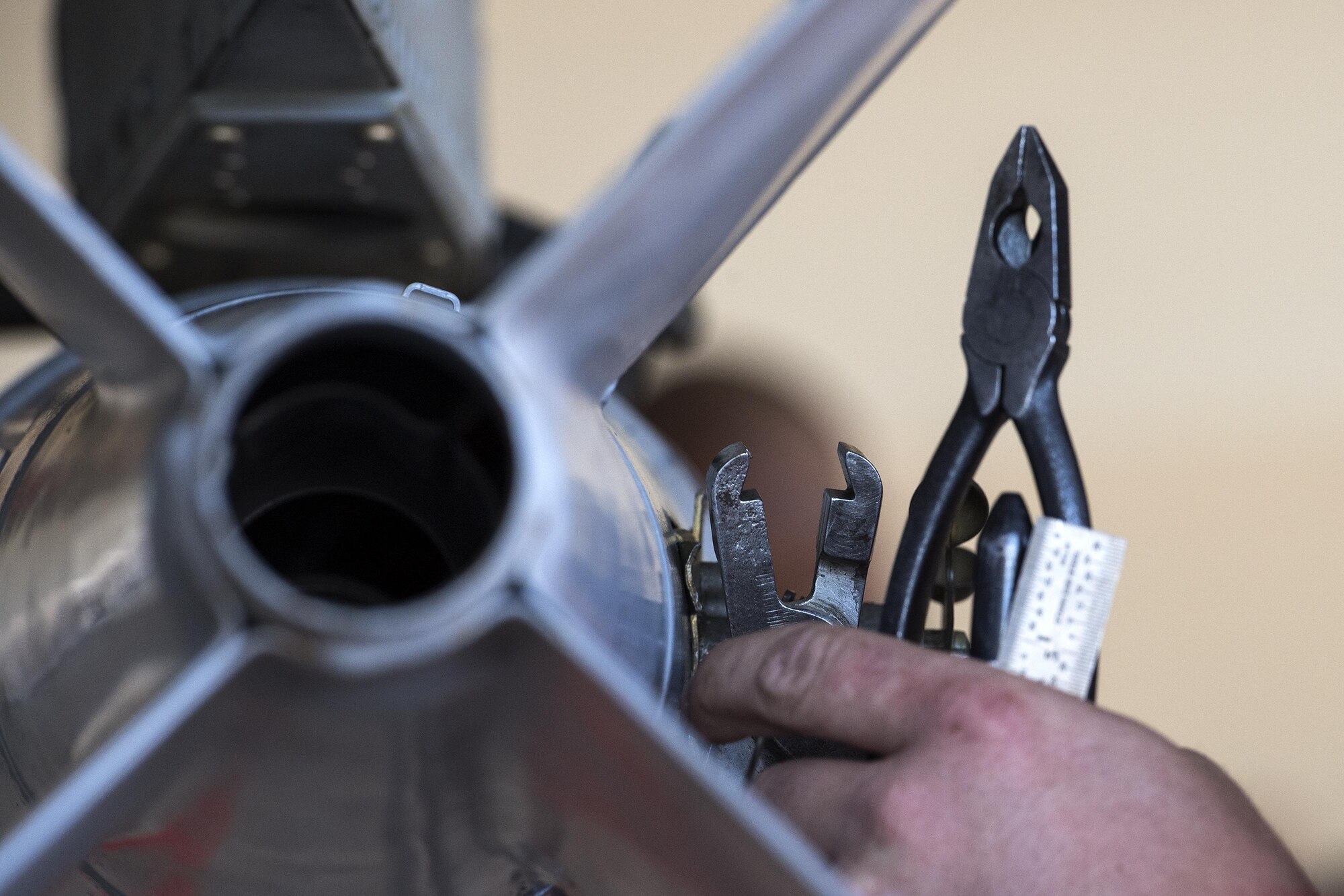 Senior Airman Keegan Gibson, 75th Aircraft Maintenance Unit weapons load team member, secures an inert MK-82 Low Drag missile to an A-10C Thunderbolt II during the weapons load competition, Oct. 14, 2016, at Moody Air Force Base, Ga. Load crews used attention to detail and technical orders to prevent discrepancies. (U.S. Air Force photo by Airman 1st Class Janiqua P. Robinson)