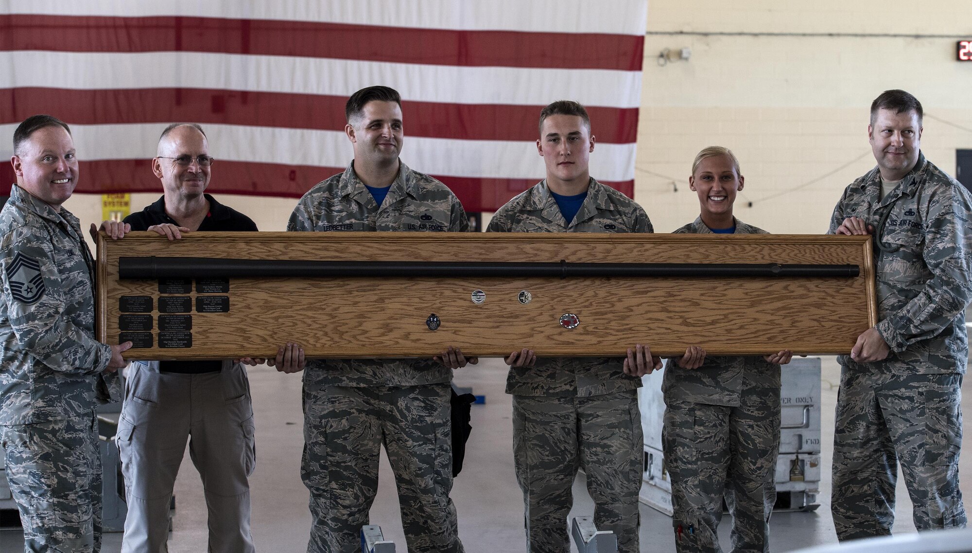 Airmen from the 74th Aircraft Maintenance Unit pose for a photo with 23d Maintenance Group leadership after winning a weapons load competition, Oct. 14, 2016, at Moody Air Force Base, Ga.  The 74th AMU defeated the 75th AMU for the quarter. (U.S. Air Force photo by Airman 1st Class Janiqua P. Robinson)