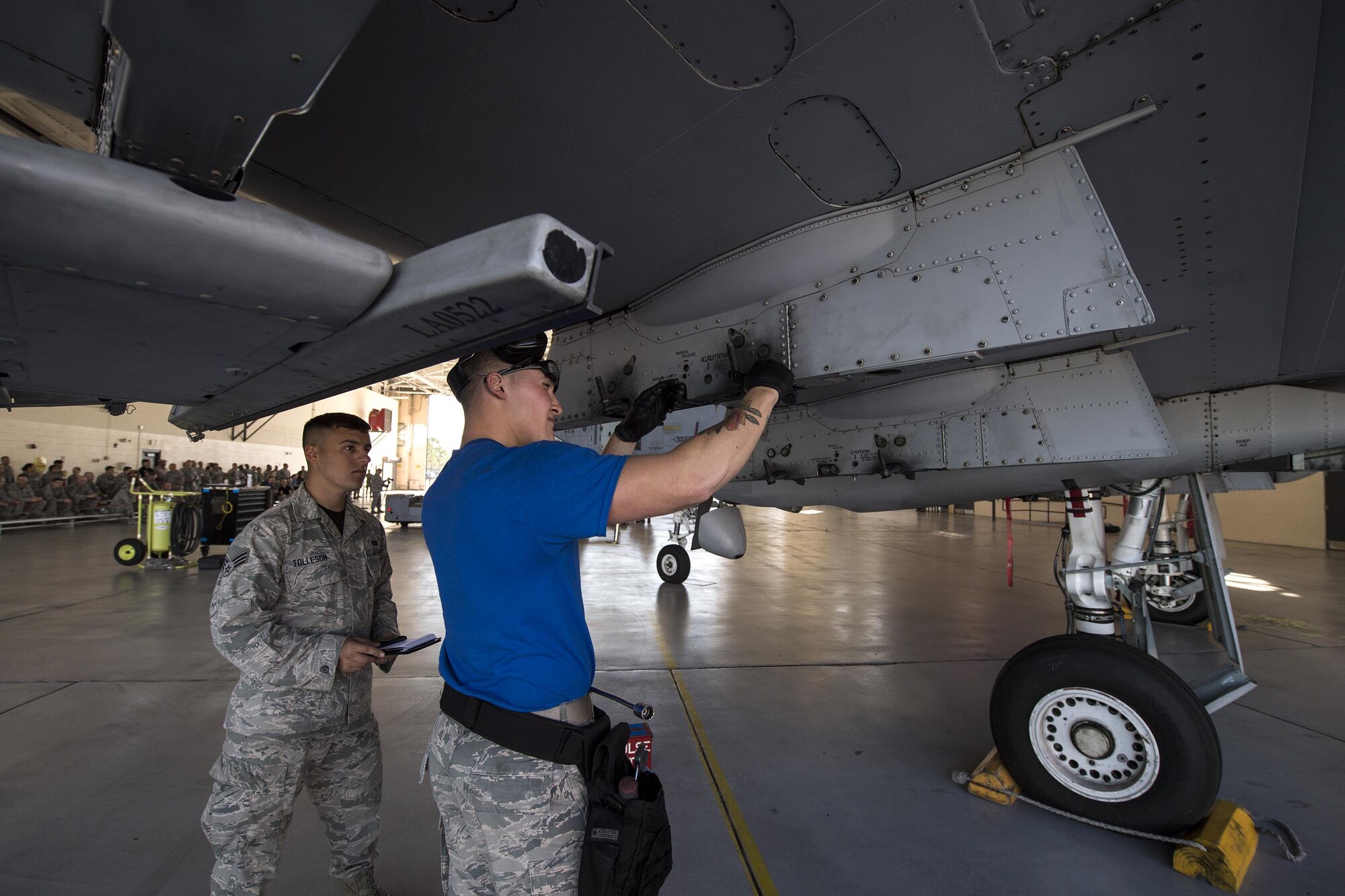 Senior Airman Dustin Tolleson, 23d Equipment Maintenance Squadron load competition evaluator, judges Airman 1st Class Weston Ley, 74th Aircraft Maintenance Unit weapons load crew member, as he performs functional checks during a weapons load competition, Oct. 14, 2016, at Moody Air Force Base, Ga. Judges evaluated the 74th and 75th AMUs based on dress and appearance, a knowledge exam and loading various munitions to determine the swiftest and most efficient load crew. (U.S. Air Force photo by Airman 1st Class Janiqua P. Robinson)