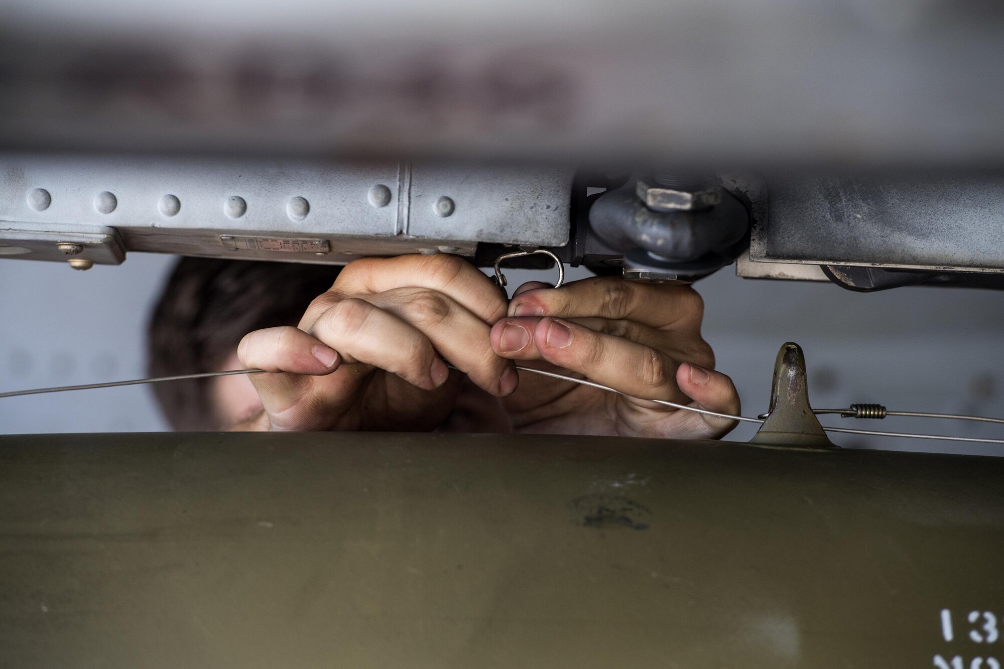 Staff Sgt. Robert Mills, 75th Aircraft Maintenance Unit weapons team chief, secures an inert MK-82 Low Drag missile to an A-10C Thunderbolt II during a weapons load competition, Oct. 14, 2016, at Moody Air Force Base, Ga. Load crews had to work together to ensure weapons were properly loaded. (U.S. Air Force photo by Airman 1st Class Janiqua P. Robinson)